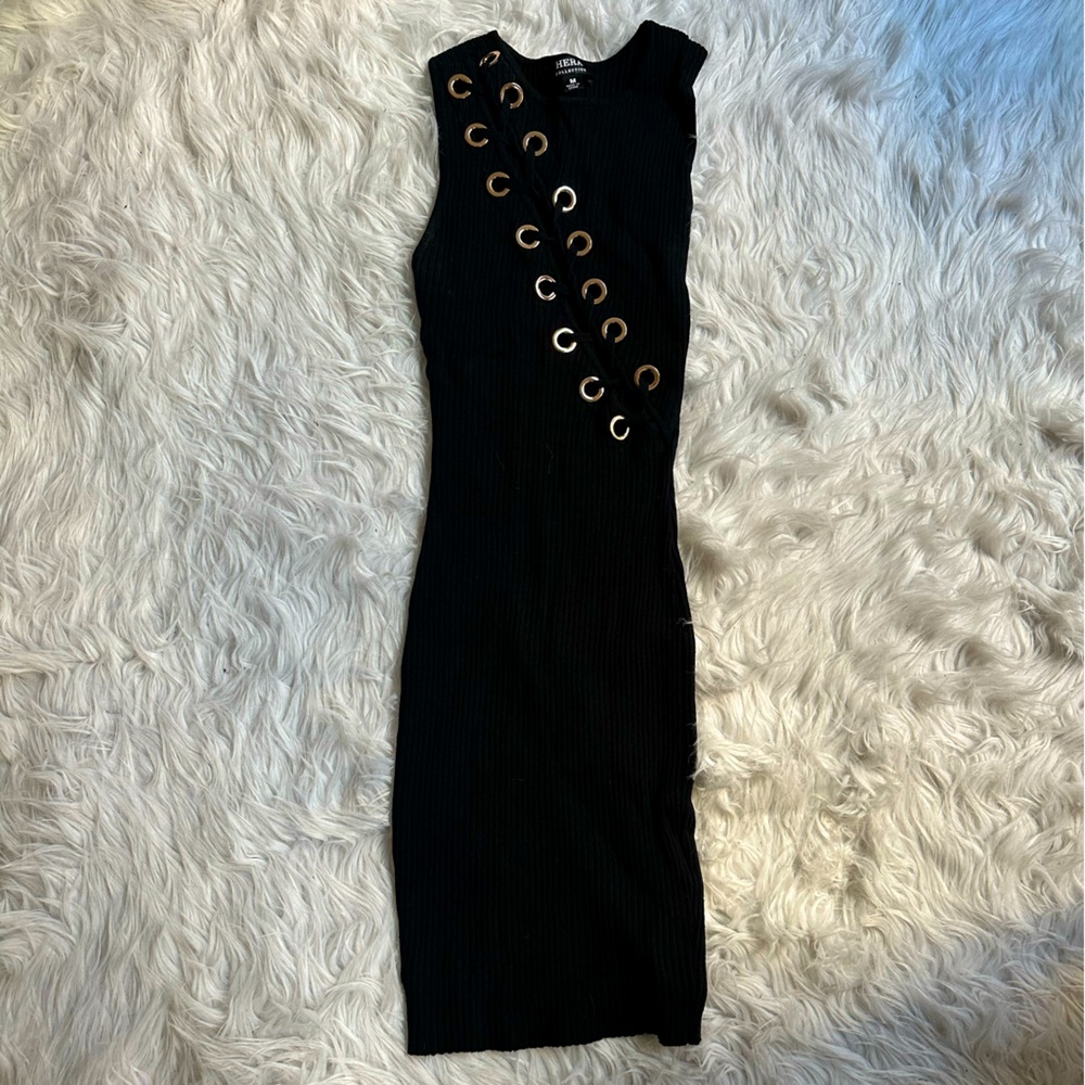 Stretchy, black dress with gold embellishments across the chest